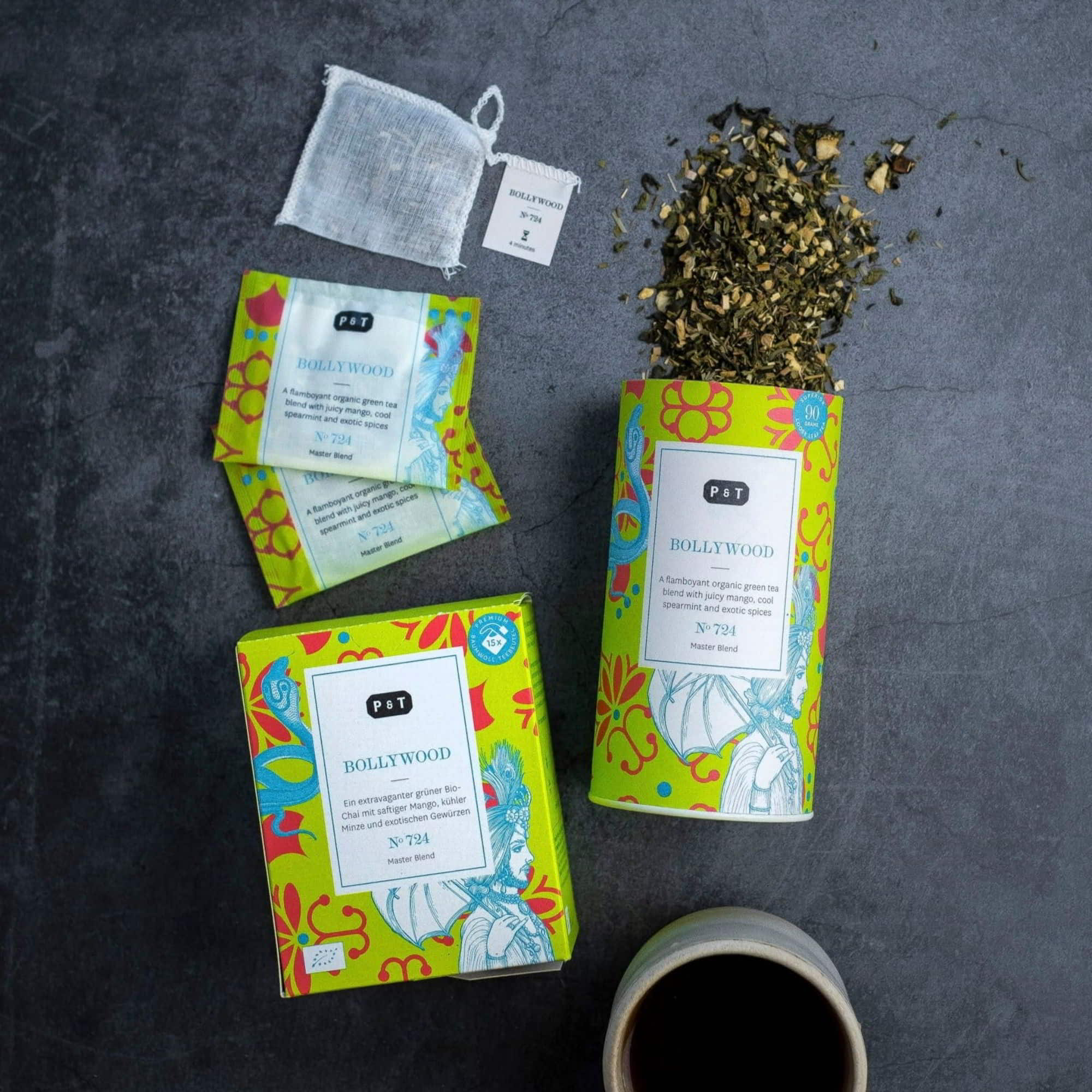 Gelbe BOLLYWOOD Tee-Verpackung von P & T mit buntem Muster, losem Bio-Grüntee, Teebeuteln und Tasse.